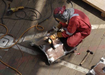 Worker in the working suit fixing metal rack