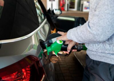 Close up hand pumping gas in car